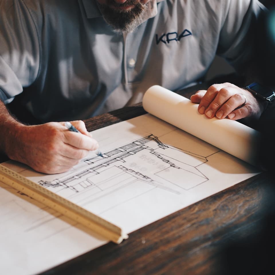 Residential construction team reviewing field conditions and planning notes